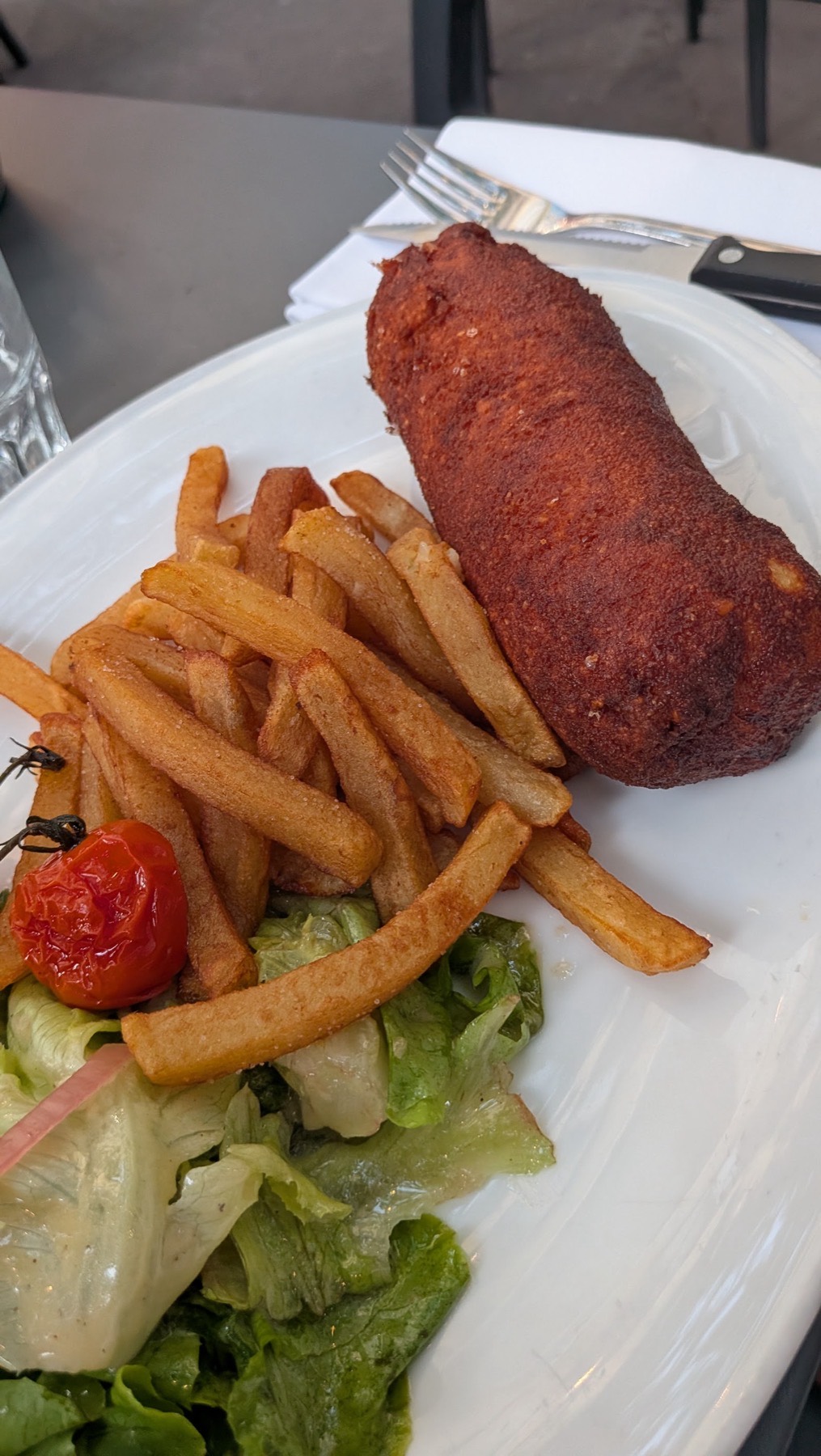Un cordon bleu doré, des frites maison et une salade verte